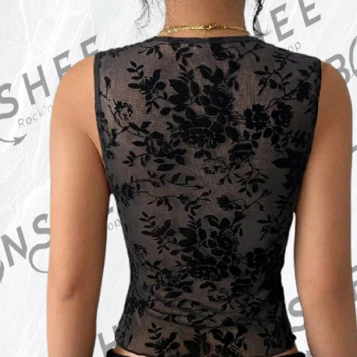 Dos d'un top noir en mesh transparent à motif floral