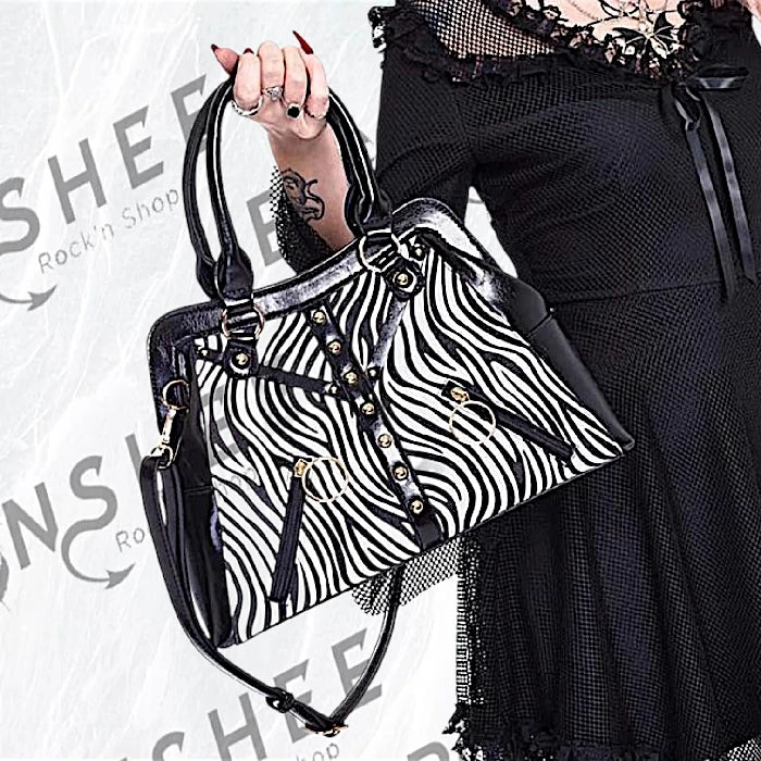 Sac à main zébré noir et blanc avec sangles et rivets